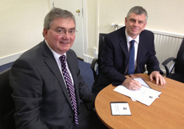Bruno Longmore, left, Head of NRS Government Records Branch receiving the RMP of Scottish Legal Aid Board from Graeme Hill, right, Director of Corporate Services and Accounts
