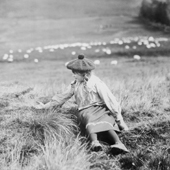 Photograph of a young girl trying to pet a small bird on a hillside, late nineteenth century (Crown Copyright, National Records of Scotland, GD391)