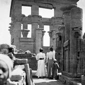 Photograph of two victorian ladies and an Egyptian boy walking amongst the ruins of the Temple of Horus at Edfu, Egypt, Nile Pleasure Cruise, 1898 (Crown Copyright, National Records of Scotland, GD268/1055/50c)