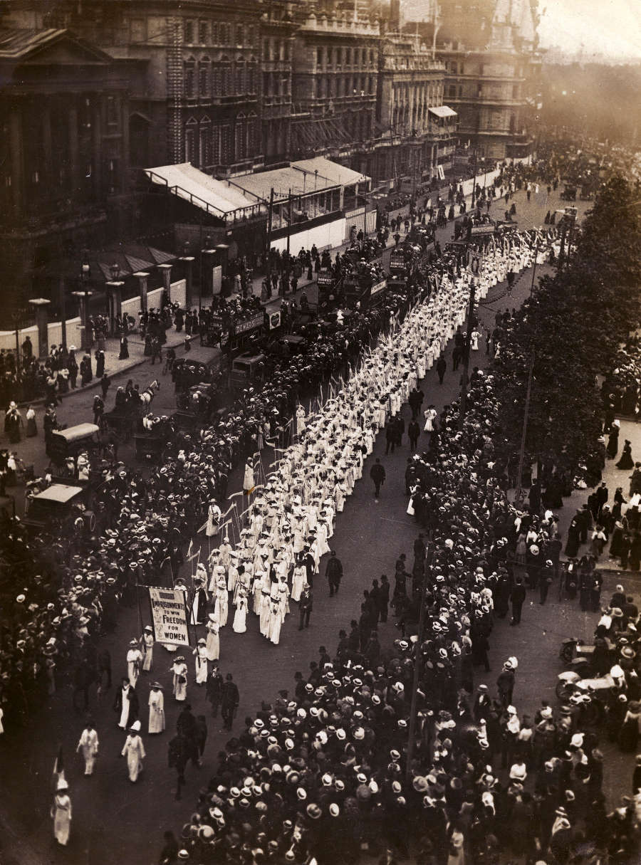 Photograph of a procession of women and surrounding crowds. This was the ‘Prison to Citizenship pageant’ in 1911.