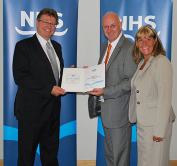Image of Pete Wadley, Public Records Officer, (left) accepting the records management plan of NHS Fife from CEO John Wilson and Records Manager Ann Allan.